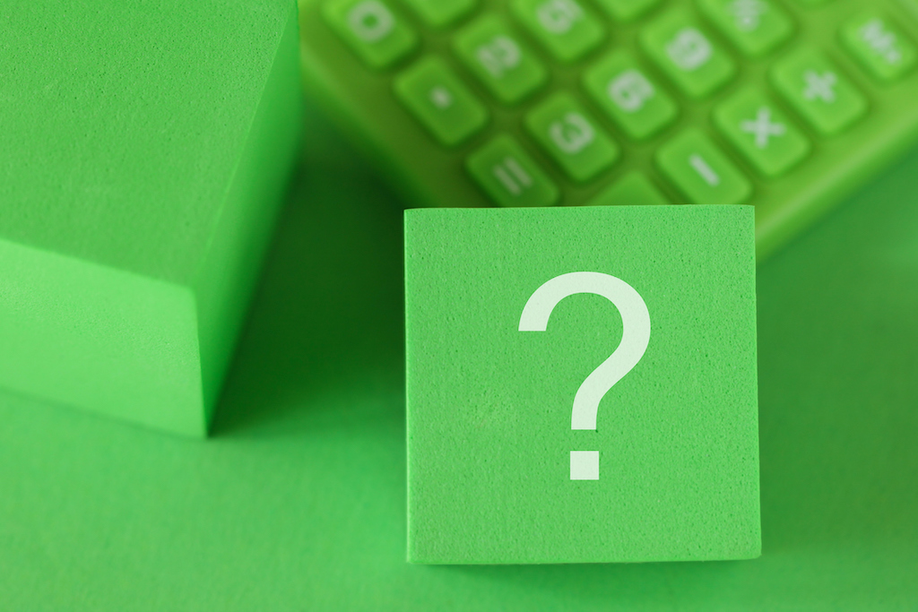 Question mark sign on block cube, green calculator, green background. For drain cleaning