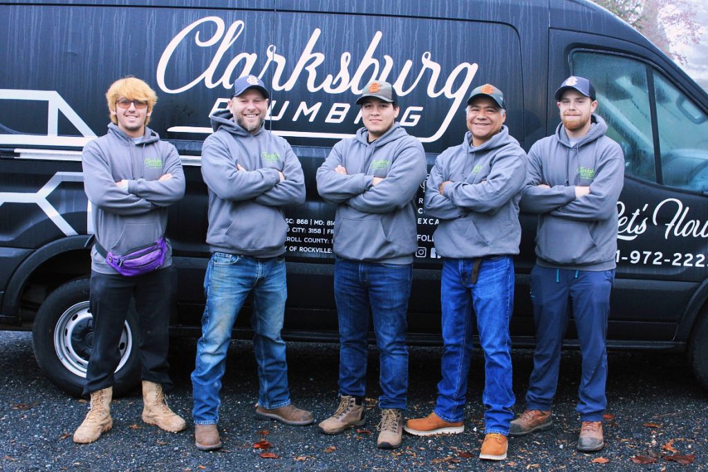 Techs in front of Clarksburg plumbing van