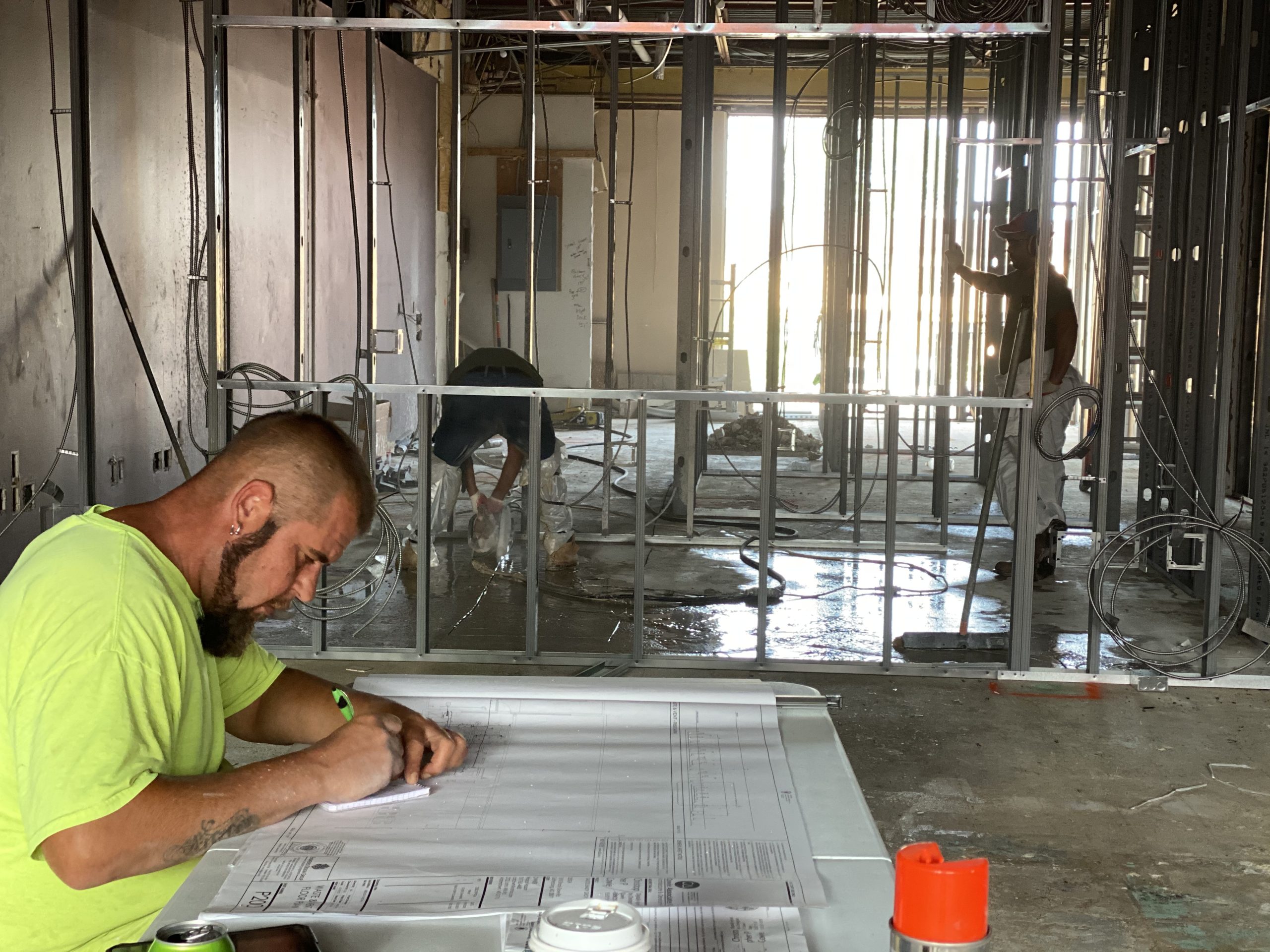 tech looking at site plans for plumbing